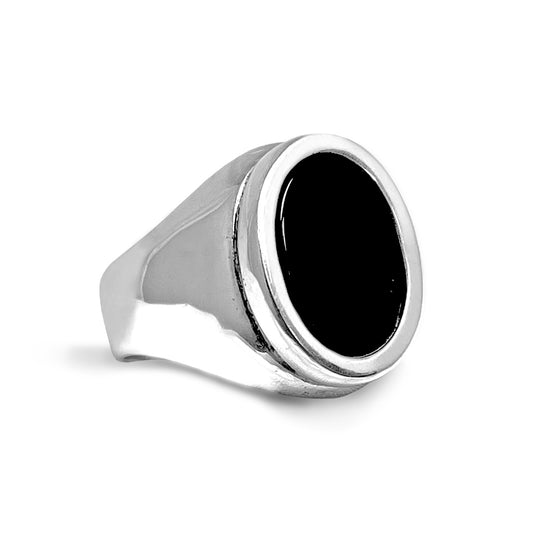 A silver signet ring with a black onyx centerpiece.