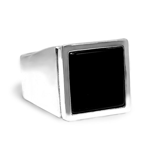 A square onyx signet ring with a silver band on a white background.