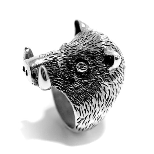 A silver ring featuring a detailed design of a wild boar, with a textured finish.