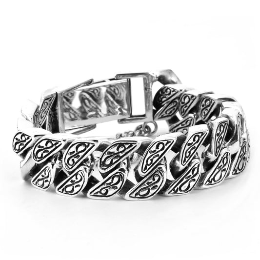 A sterling silver bracelet with lion engraving, displayed on a neutral background.