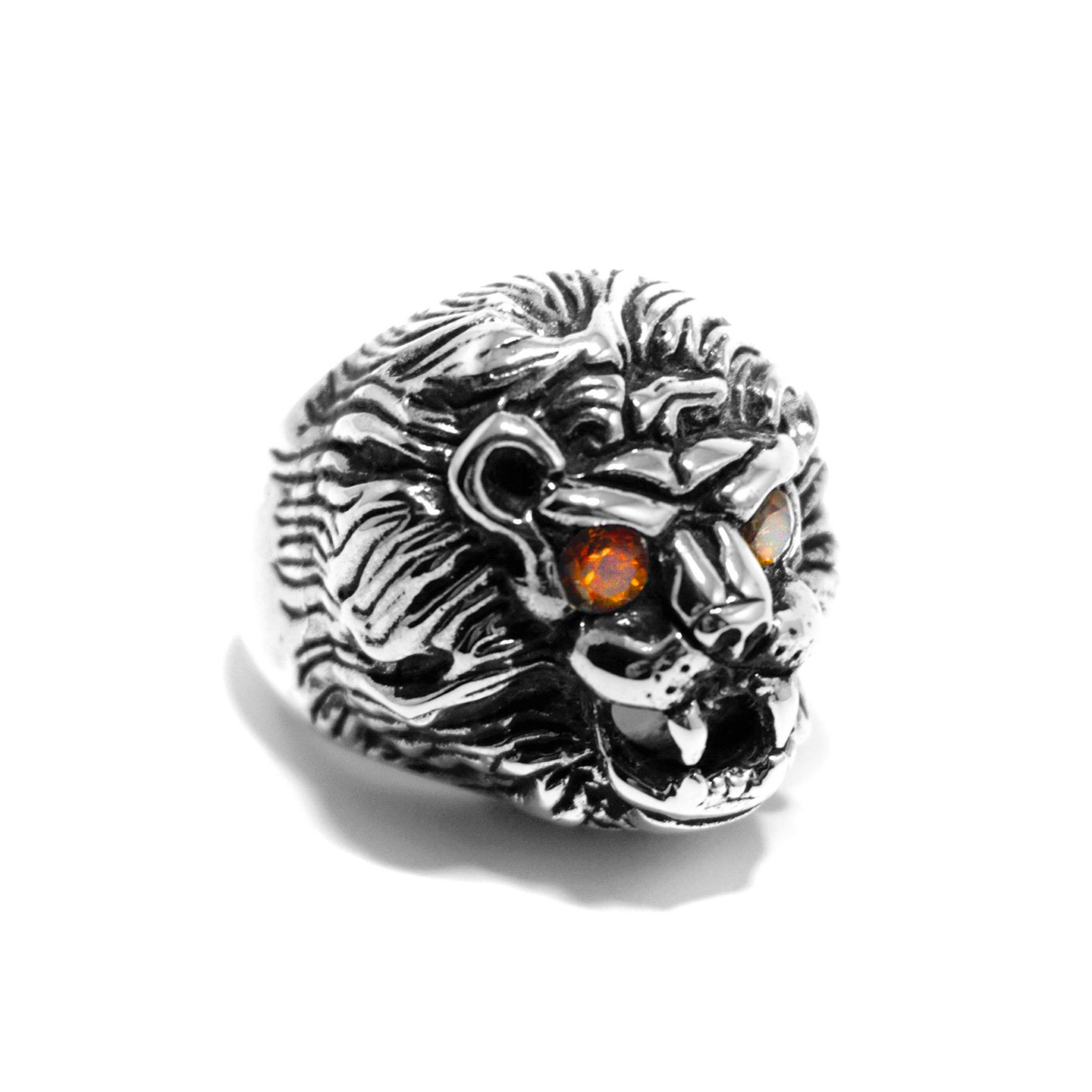 A silver ring with a design resembling a lion's face, featuring natural citrine stone eyes, handcrafted in the USA.