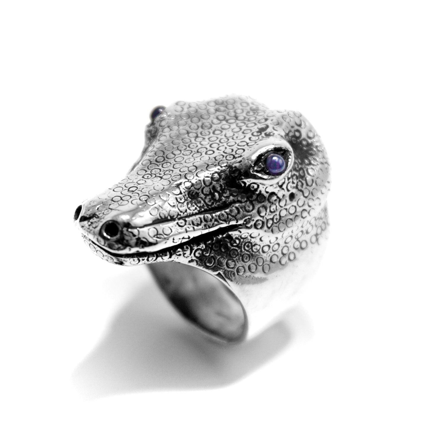 Silver crocodile ring with sapphire eyes.