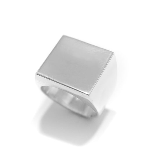 A square polished silver signet ring. 
