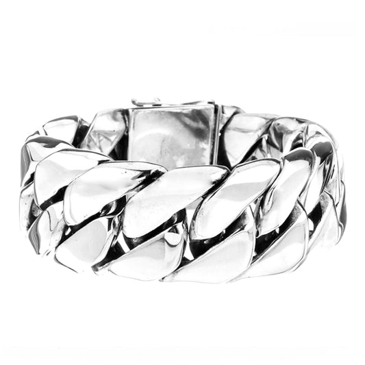 A sterling silver thick and heavy link bracelet with a smooth surface and light oxidation effect. 