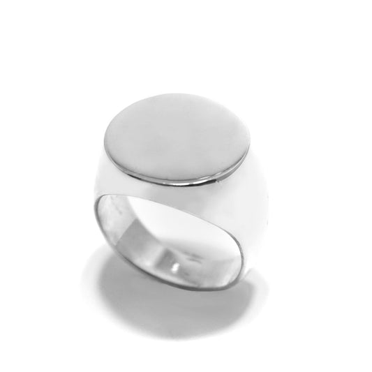 A round signet ring with a polished silver finish on a white background.