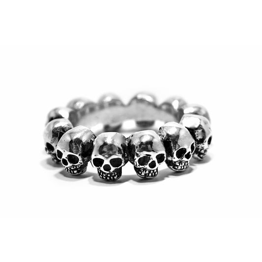 A silver ring with multiple skull designs, crafted from .925 sterling silver and handcrafted in the USA.