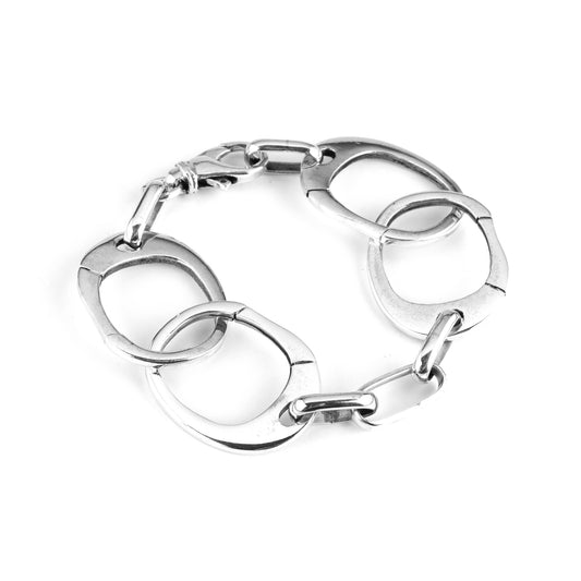 A silver bracelet with a series of interlinked handcuff-inspired links like Keith Richards. 