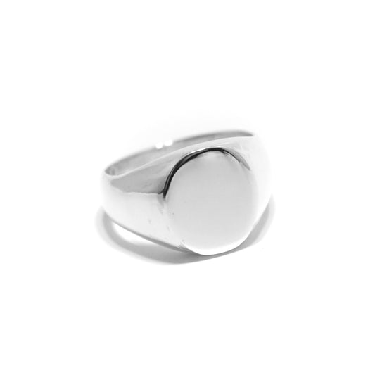 A small oval signet ring made of .925 sterling silver with a polished finish, displayed on a white background.